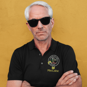 Man wearing a black polo with the MacLaine clan crest embroidered on the left chest.